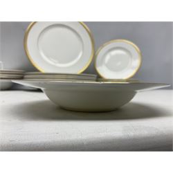 Royal Doulton Royal Gold pattern tea and dinner service for eight, comprising dinner plates, side plates, tea plates, soup bowls, sauce boat and saucer, dessert bowls, coffee cans and saucers, teacups and saucers and two lidded tureens