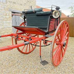 Holland & Holland Tandem Cart - Althorp Spencer Family Estate

A two wheeled tandem cart or cocking cart by Holland & Holland Coach Builders, London, with black painted bodywork, red painted shafts and running gear, red wooden spoked wheels with rubber tyres, green upholstered seating and a rear perforated metal footboard. The cart is fitted with carriage lamp brackets (lamps next lot), green buttoned cushions with leather retaining straps, side louvered body panels, footrests, leaf spring suspension and shafts for horse use. The carriage incorporates an adjustable body position, operated by a lever, allowing the body to be moved forwards or backwards to alter the weight distribution. Formerly owned by the family of Lady Diana Spencer,
Sympathetically conserved by Woods of Fairbourne Carriages Ltd, Kent.

Features:
• Brass maker’s plaque for Holland & Holland Coach Builders, London
• Two wheeled tandem cart
• Black painted body with red painted shafts and running gear
• Red wooden spoked wheels with rubber tyres
• Green upholstered cushions with leather retaining straps
• Adjustable carriage body for weight distribution
• Lever operated adjustment mechanism
• Perforated rear footboard
• Side footrests
• Louvered side panels
• Leaf spring suspension
• Rear opening storage compartment
• Decorative painted armorial motif to rear panel
• Fitted carriage lamps shown, not included in the lot (available as next lot)
• Conserved by Fairbourne Carriages Ltd
• Provenance: The Althorp Attic Sale including The Spencer Carriages, lot 195, 7 July 2010

Dimensions:
Overall length 396 / 198cm
Width 155cm
Height 190cm

Wheel Diameters:
Wheels: 148cm

Seating:
Driving seats: 2
Passenger seats: 2