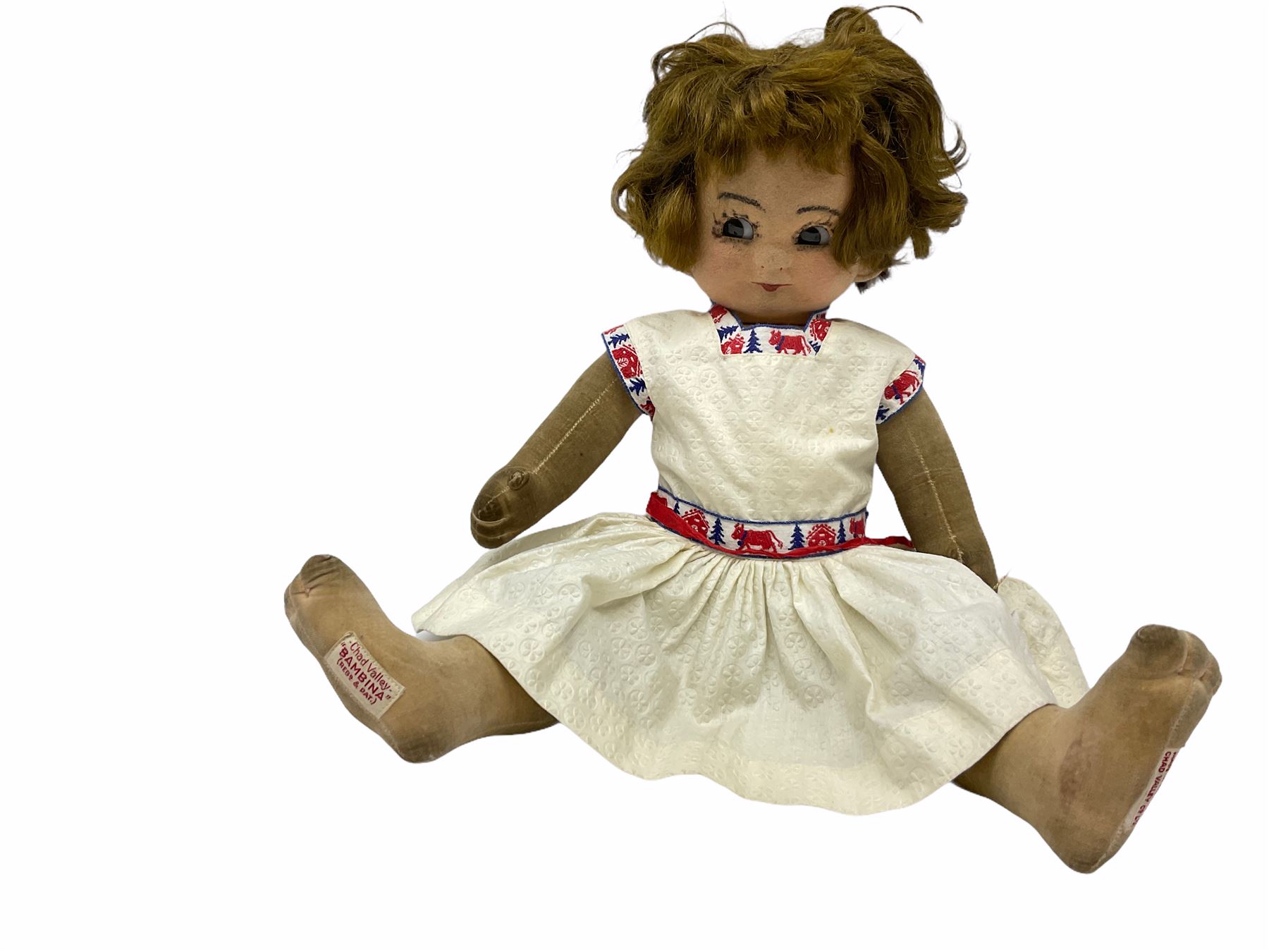1920s Chad Valley 'Bambina' doll, the pressed felt head with applied hair, side glancing inset glass eyes, painted facial features and velvet jointed body, Hygenic and Bambina labels to the feet H46cm