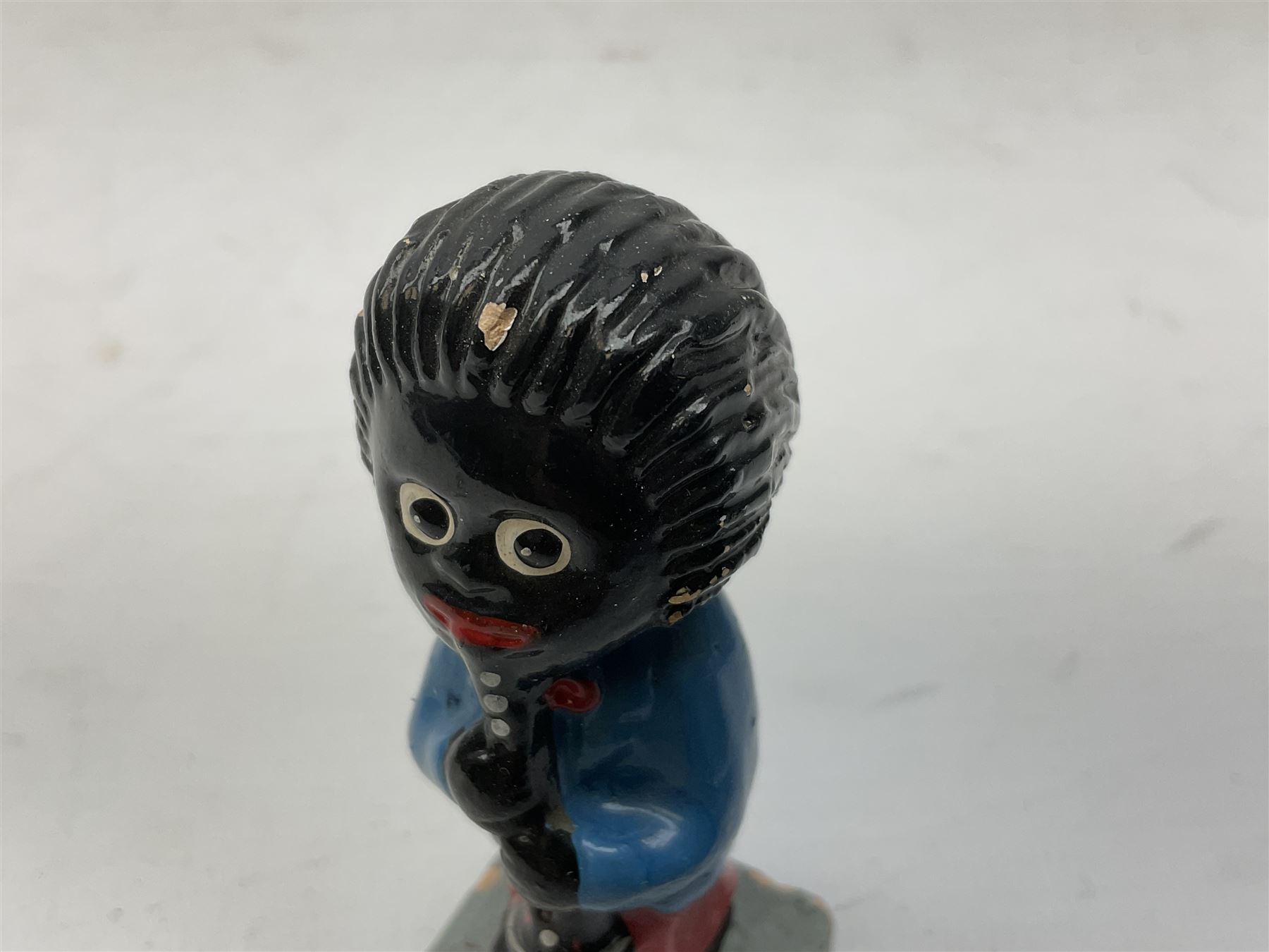 Robinson Jam plaster Golly band, including drummer and singer, H7.5cm

Originally handmade by mothers in Africa for their children from old fabric and cloth, the golly doll was adopted as the mascot and trademark for the Robertson's confectionery brand around 1910 after the company's founder John Robertson visited the US and noticed children playing with them. Robertson's Gollies have been collected by people across the UK and around the world for generations but garnered a contentious image in the 1980s because of links to racism. The trademark was removed from Robertson's branding in 2001.