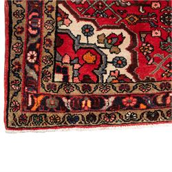 North West Persian runner, the red field decorated with an all-over Herati pattern of diamond lattice motifs, rosettes and serrated leaves, ivory floral spandrels, enclosed by an indigo palmette border and narrow floral guard bands