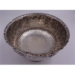 Late Victorian silver rose bowl, of circular form with embossed foliate and C scroll decoration, and engraved personal dedication, upon a part fluted spreading circular foot, hallmarked Wakely & Wheeler, London 1898, H11.5cm D18cm, approximate weight 11.67 ozt (363.2 grams)