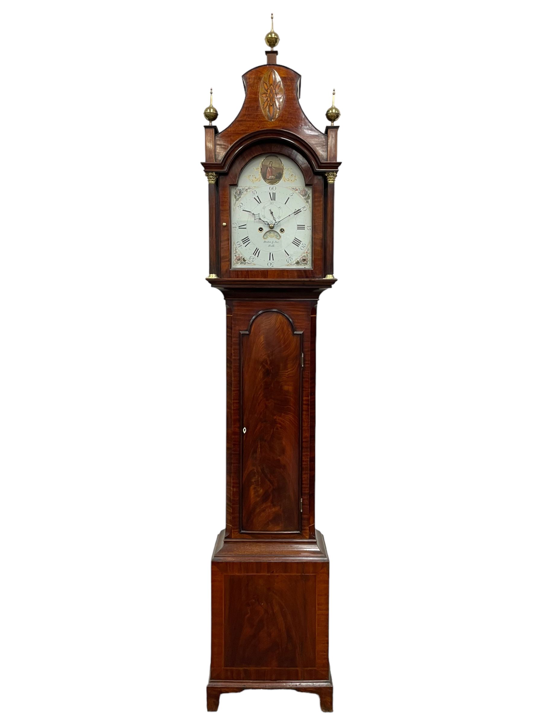 Denton & Fox of Hull – Early 19th century mahogany 8-day longcase clock c1802, pagoda pediment with an oval inlay and three ball and spire finials, break arch painted dial and hood door flanked by reeded pilasters with brass Corinthian capitals, long trunk door with conforming break arch top on a rectangular plinth raised on bracket feet, early Wilson (Birmingham) dial with Roman numerals, five minute Arabic’s and minute dots, subsidiary seconds dial and calendar aperture, with matching steel hands, floral spandrels within raised gesso work and a conforming oval depiction of a young maiden and dog to the break arch, dial pinned via a falseplate to a rack striking movement with a recoil anchor escapement striking the hours on a cast bell. With pendulum and weights.
Joseph Denton was a respected and prolific Hull clock maker working in Scale Lane Hull 1779 and Silver Street 1782-1814. Entering a short-lived partnership with Charles Fox from Beverley in 1802.
