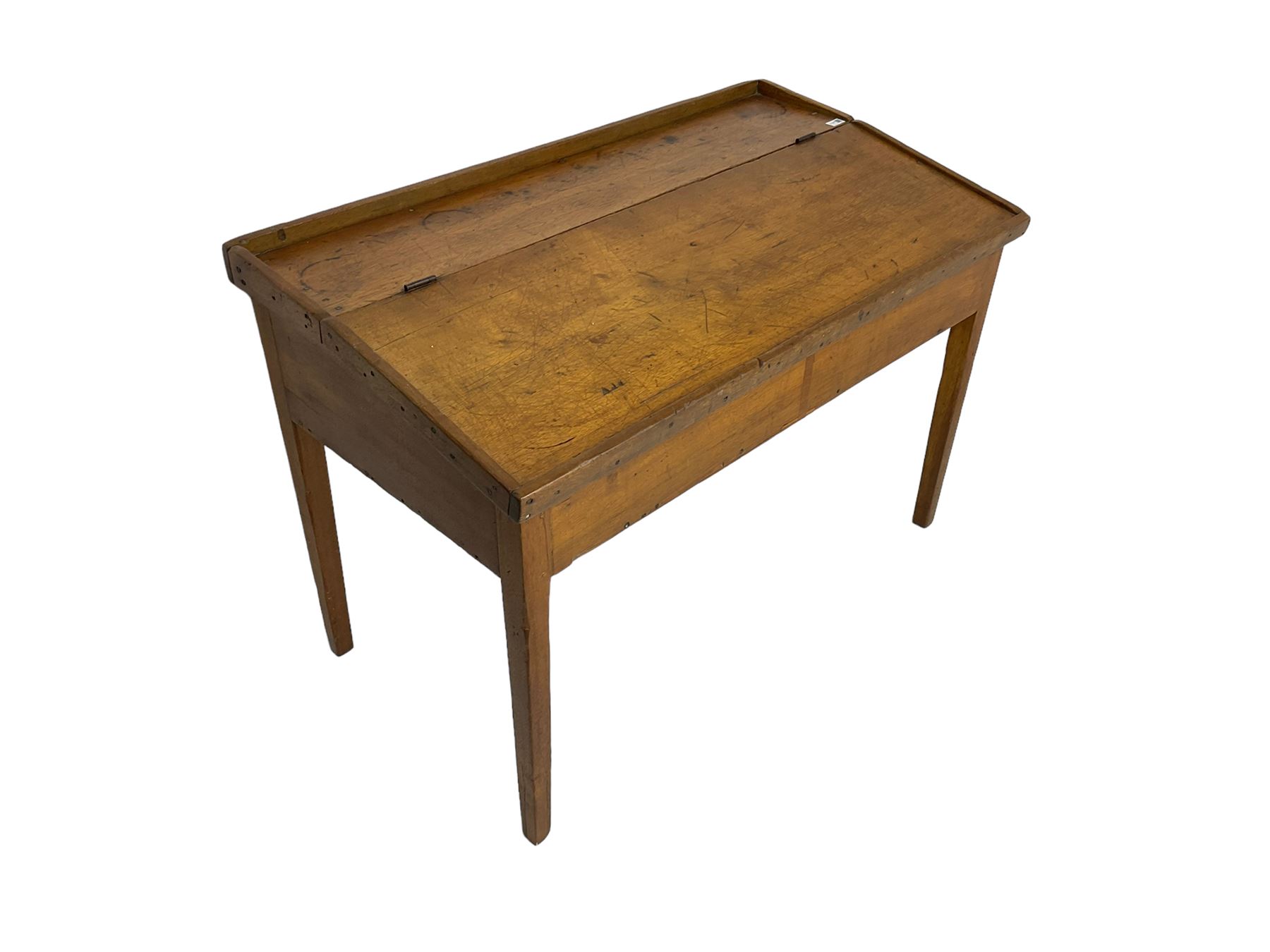 Late 19th century walnut school desk, sloped hinged lid, on square tapering supports 