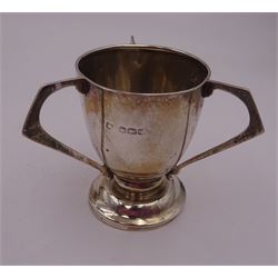 Group of silver, to include 1920s silver egg cup, modelled as a tyg with three angular handles, hallmarked James Deakin & Sons, Sheffield 1923, 1930s silver egg cup, of plain typical form engraved with initials, hallmarked Viner's Ltd, Sheffield 1935, cased fork and spoon, silver pusher and two silver napkin rings, all hallmarked  