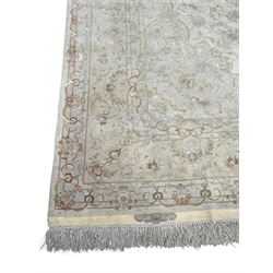 Persian Mahal densely knotted ivory ground carpet, floral rosette medallion surrounded by interlacing leafy branches and palmettes, scrolling border decorated with foliate motifs, within guard stripes, with signature panels to each end