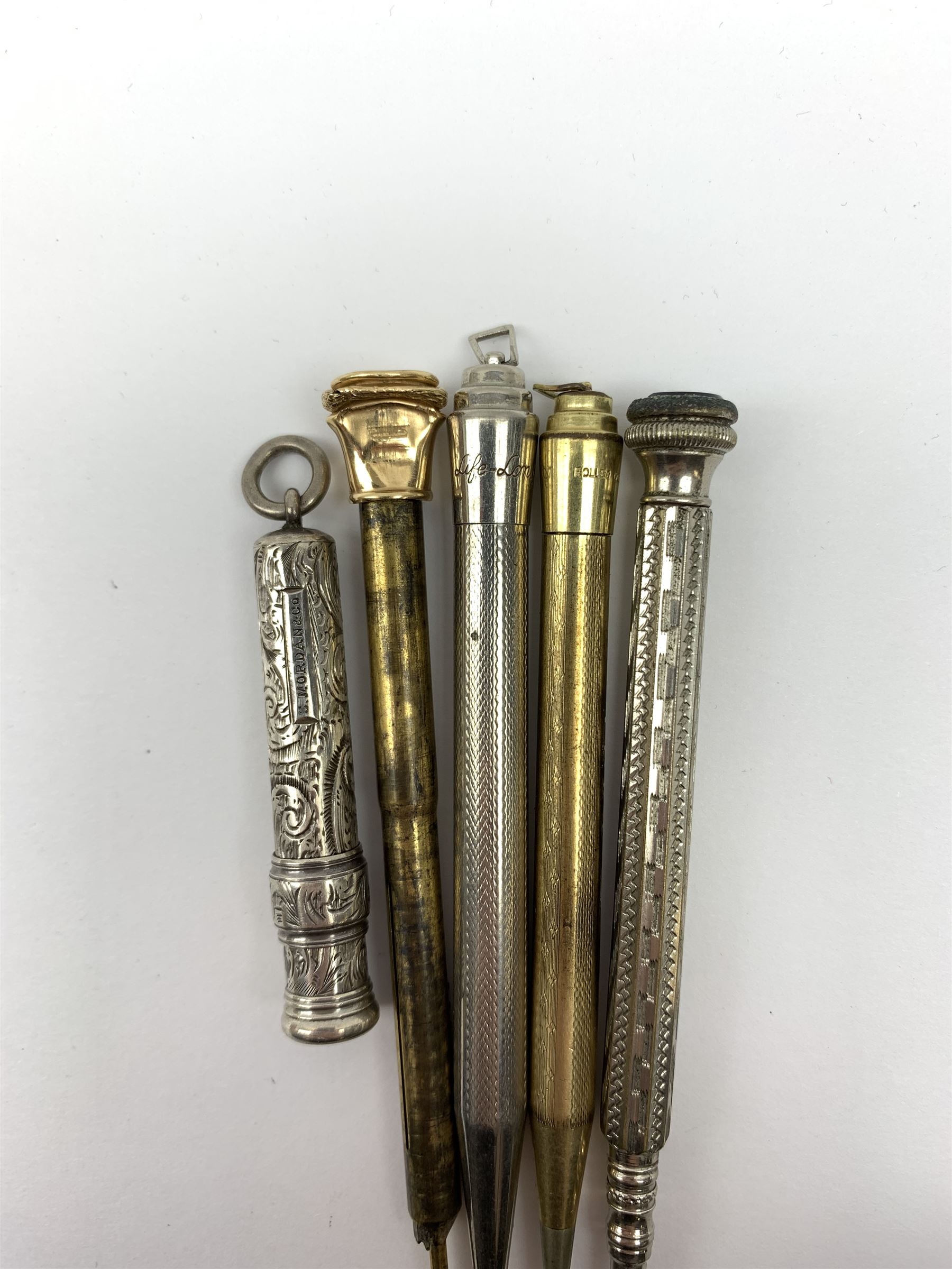 A late Victorian Sampson Mordan & Co silver push action propelling pencil, with foliate engraved decoration and suspension ring terminal, hallmarked Sampson Mordan & Co, London 1896, together with a group of vintage pens including examples by Eversharp, a number marked Silver Plated, Rolled Gold, and Gold Filled. 