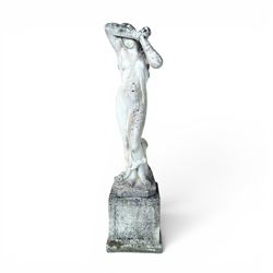 Weathered cast stone garden statue of a 'Shy Maiden', raised on square plinth base