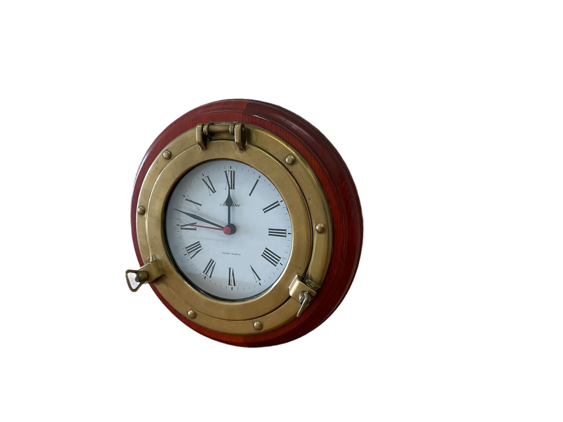 20th century marine clock with a mahogany surround and cast brass “porthole” bezel, with a 6” dial and Swiss battery operated quartz movement.