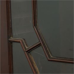 Early 20th century Chippendale design mahogany bookcase, projecting moulded cornice over four astragal glazed doors, the interior fitted with adjustable shelves, on bracket feet 