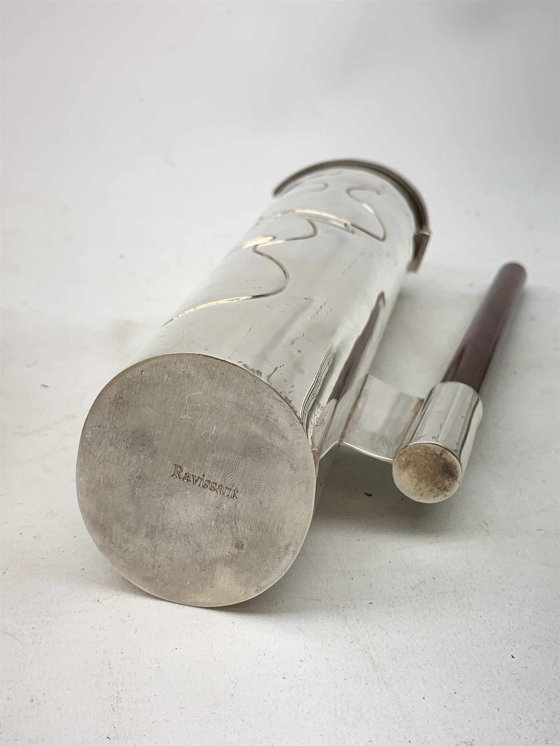 A silver plated Ravissant water jug, of cylindrical form with wooden open handle, detailed with a group of vases, marked beneath Ravissant, H25.5cm.  
