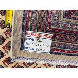 Northwestern Persian Bottehmir hand-knotted rug, ivory field with an all-over design of boteh motifs arranged in diagonal rows within multiple borders and a primary madder red field with stylized vine and flowerhead motifs, 320cm x 214cm 