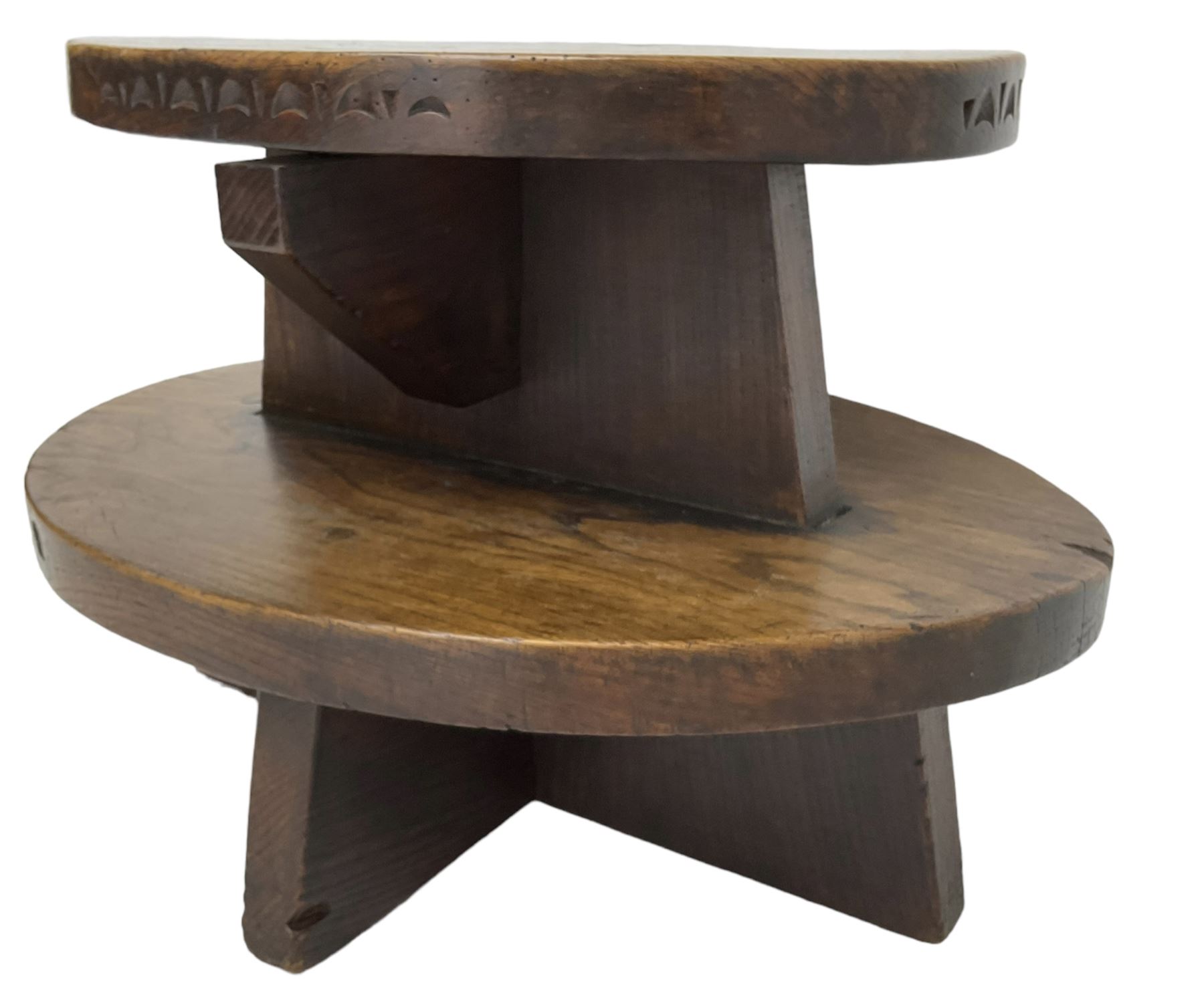 20th century figured elm occasional table, two oval tiers raised on cruciform base, the top tier carved with incised decoration 