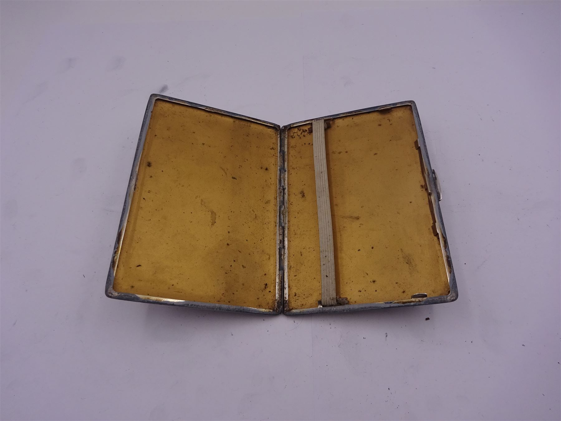 1940's silver cigarette case, with engine turned decoration and engraved monogram to panel to upper left corner, hallmarked Smith & Bartlam, Birmingham 1941, H12.5cm, approximate weight 6.09 ozt (189.5 grams)