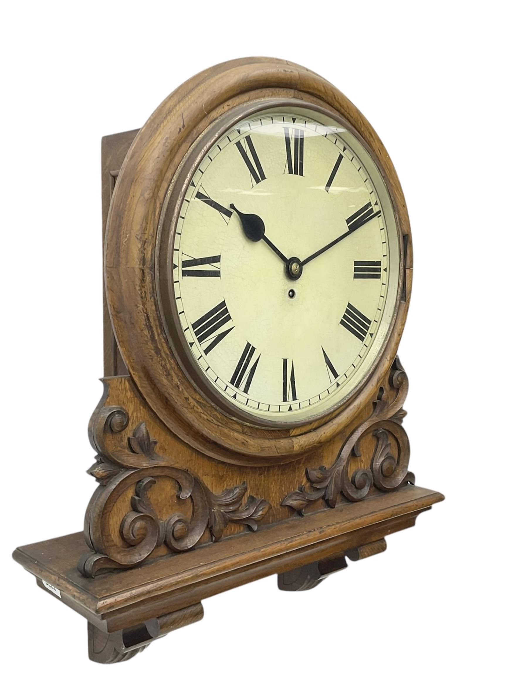 Winterhalter and Hoffmeier -  German oak cased early 20th century fusee wall clock, with a circular wooden surround and a spun brass glazed bezel to the dial, housed on an integral carved bracket with shaped corbel supports, painted dial with Roman numerals, minute track and steel spade hands, dial pinned directly to a four pillar chain driven fusee movement with a recoil anchor escapement. With pendulum and key. 
German fusee movements by Winterhalter and Hoffmeier are comparatively rare, especially housed in carved wall clocks of this description. 