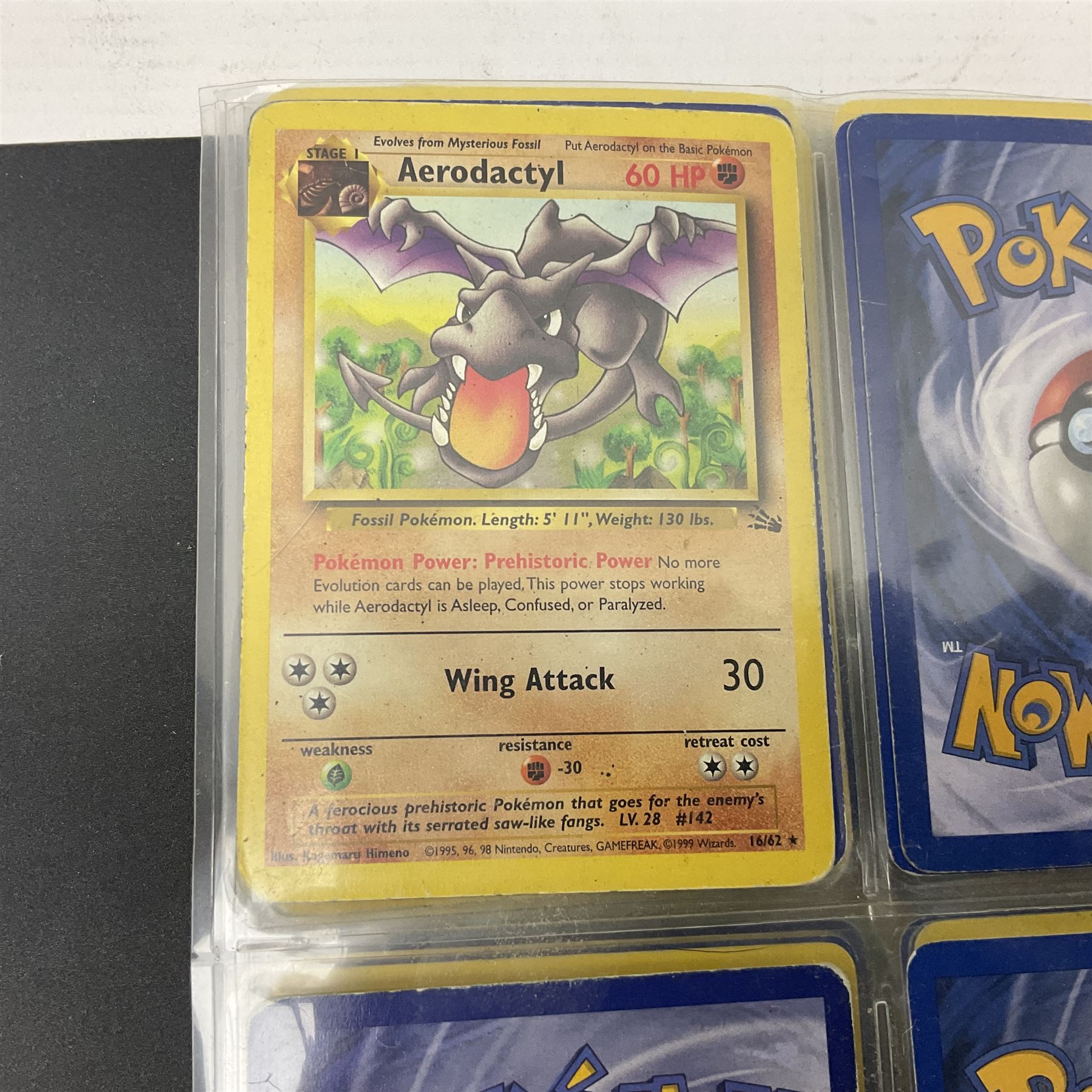 Collection of Pokemon trading cards, mostly 1999 Wizards Pokemon cards to include holo Charizard 4/102, first edition holo Machamp 8/102, further holographic cards; Dark Flareon 35/82 and Dark Vaporeon 45/82, cards from themed sets and 4th edition prints; 1998 Electronic Pokédex with cardboard boxes for themed decks Blackout, Overgrowth and Power Reserve Jungle, along with a large quantity of energy and trainer cards 