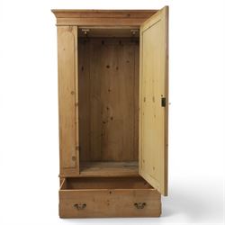 Traditional waxed pine single wardrobe, featuring single panelled door above base drawer, loop handles