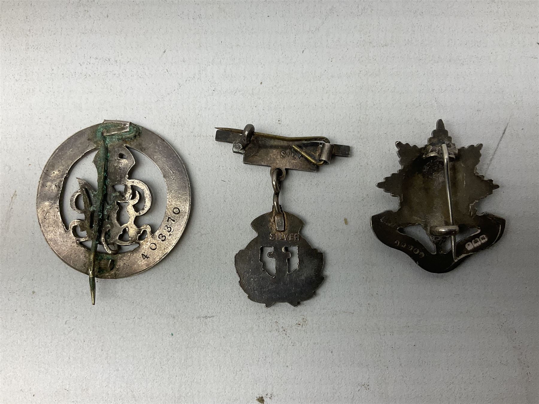 Military metal lapel and pin back badges to include stamped silver Old Coldstreamers Association example and another stamped silver badge, Royal Warwickshire examples, Glamorgan Yeomanry etc