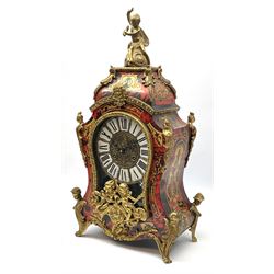 Contemporary Italian Boulle clock with a conforming wall bracket in simulated tortoise shell and brass inlay, case and bracket profusely decorated with applied gilded ornamentation depicting cherubs, figures and rococo scrollwork, brass dial with individual inset porcelain panels with roman numerals, steel serpentine hands and visible sunburst pendulum, with an eight-day twin-train striking movement, striking the hours and half hours on two bells. 
Clock H58 W33 D14
Bracket H20 W36  D18

