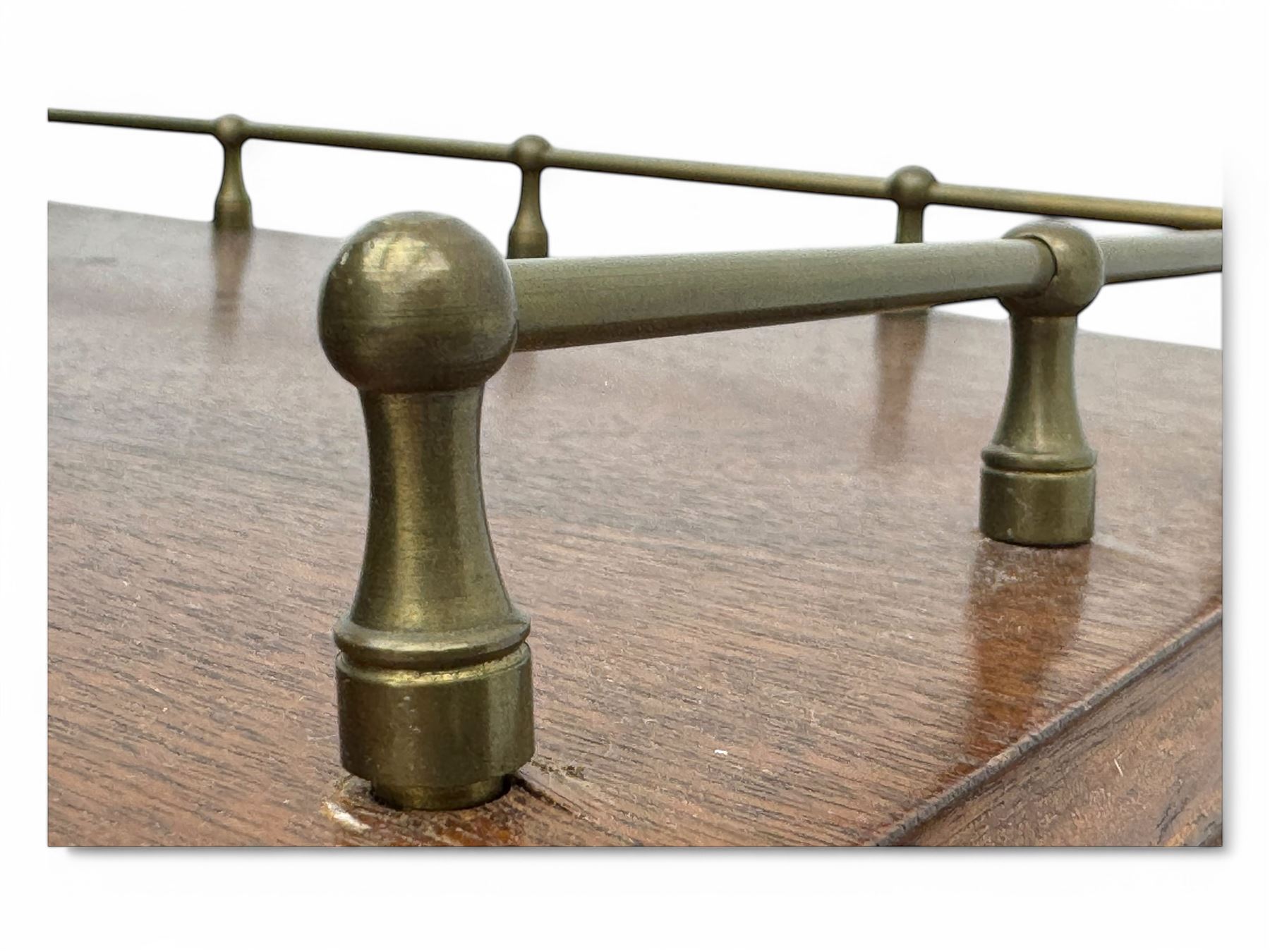 Mid-20th century mahogany open bookshelf, the rectangular top with a brass balustrade gallery, over three shelves each supported by turned column uprights, on shaped apron base
