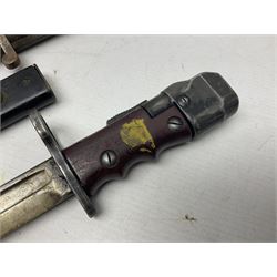 British No 7 MKI knife bayonet with 20cm single edged fullered clipped point blade;  blackened steel, large muzzle ring cross-guard; blackened swivelling pommel marked 'F5H'; red Tufnol composite grips; in blackened steel scabbard L33cm overall; British Pattern 1888 bayonet with scabbard; and German Ersatz bayonet with scabbard (3)