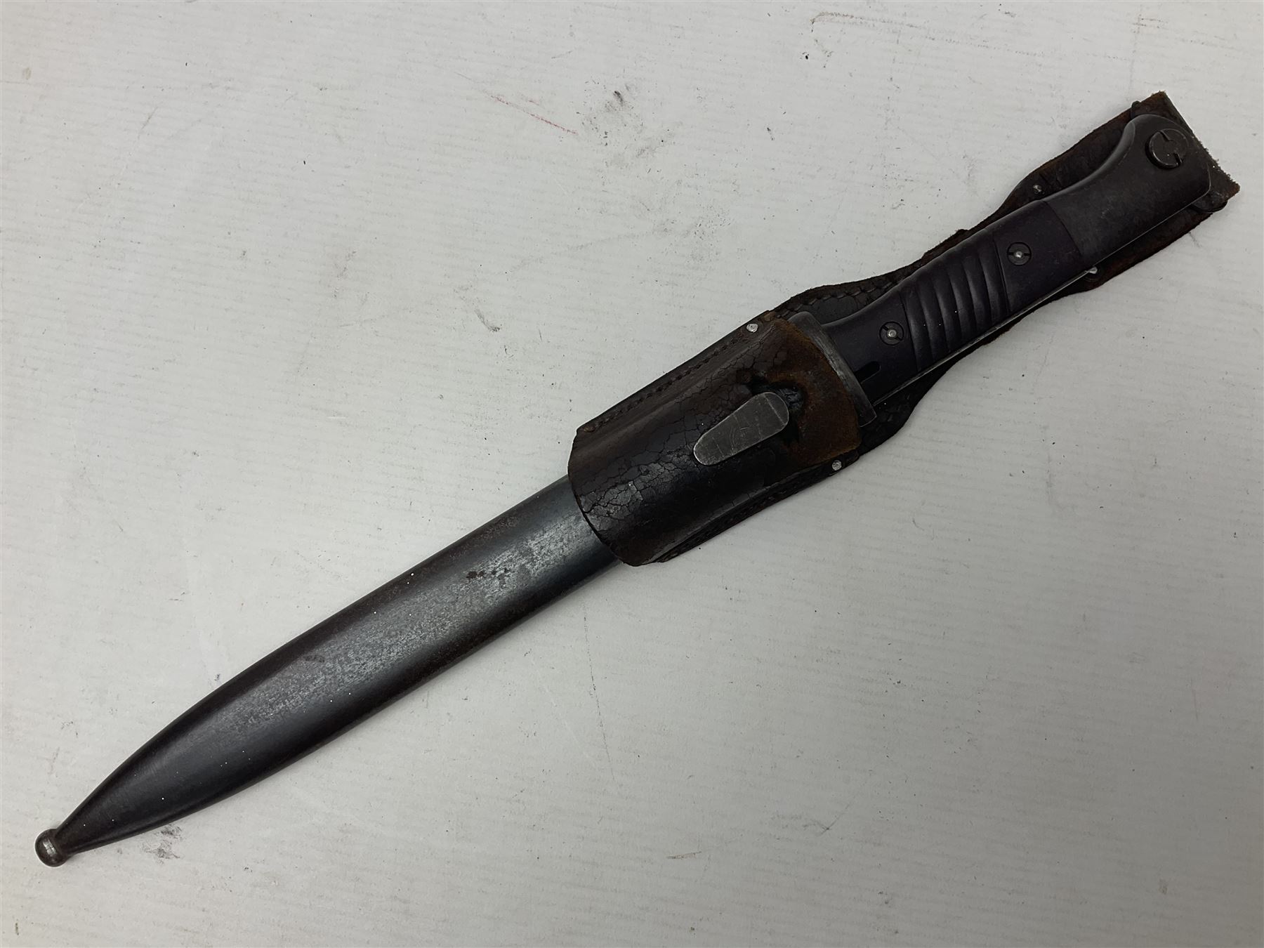 WWII German K98 Mauser bayonet by E. & F. Horster, the 24.5cm fullered blade marked 43aSW for 1943, numerous inspection marks to blade and pommel, bakelite grips and bluing to metal parts; in steel scabbard with corresponding numbers and leather frog L42cm overall