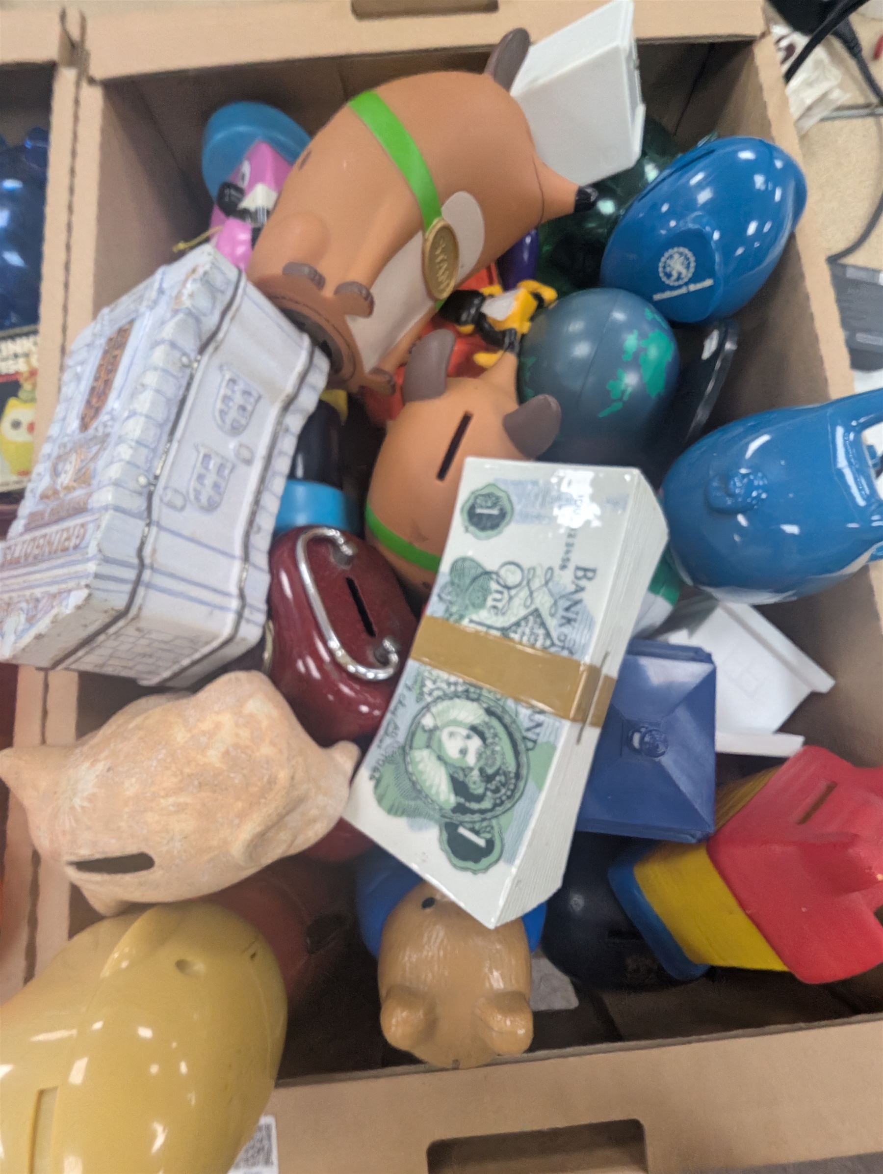 Large collection of vintage money boxes and charity boxes, including plastic, wooden, tin and ceramic examples, of various designs including Paddington, Dunlop, Jellybabies, Meerkat, Halifax Houses, Pigs, etc