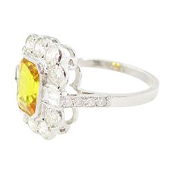 Platinum yellow sapphire and diamond milgrain set cluster ring, single octagonal cut sapphire of approx 2.20 carat, surrounded by two baguette cut diamonds and ten transitional cut diamonds and diamond set shoulders, stamped Plat, total diamond weight approx 0.95 carat