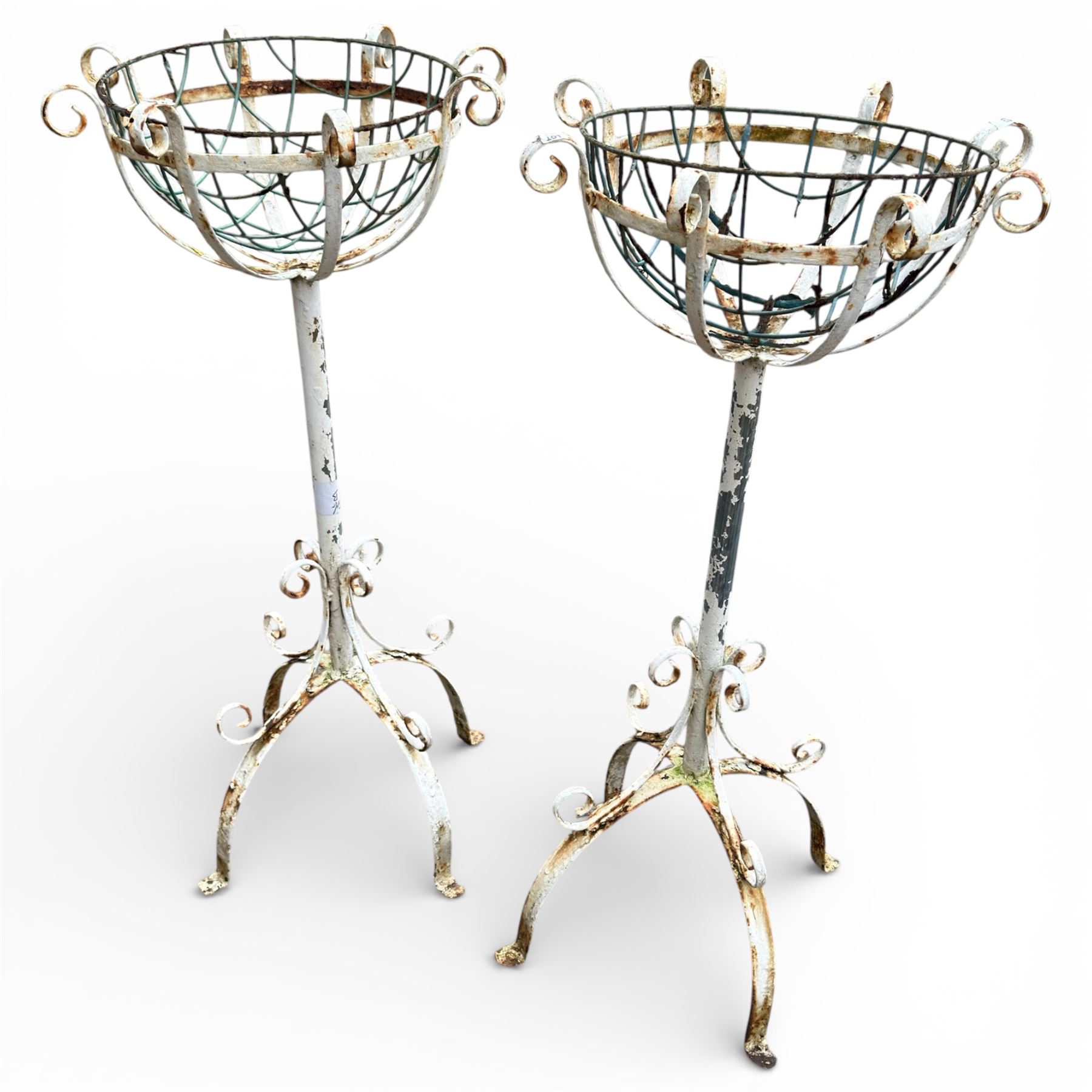 Two plant stands in a weathered white finish with wire baskets