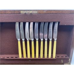 Elkington & Co part canteen of silver plated and stainless steel cutlery, to include simulated ivory handled examples, housed in oak and mahogany case, lock plate stamped 'Acme, British Made', W49cm D31cm H18cm