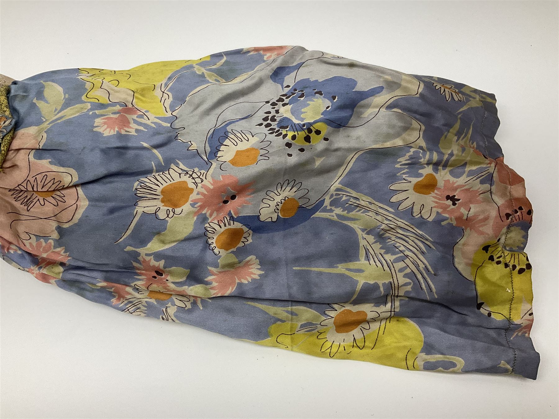 Victorian large wax over composition Pumpkin head doll, with inset dark glass eyes, moulded blonde hair in curls, stuffed body with carved and painted wooden limbs, grey painted boots, floral satin dress with netting underclothes H61cm