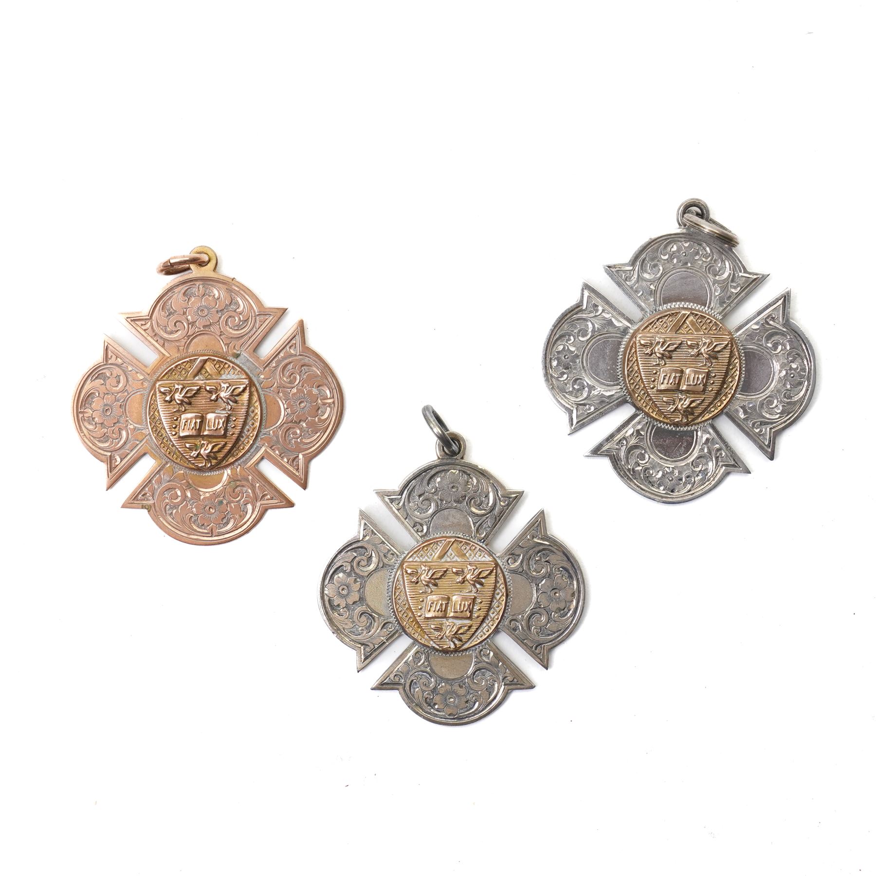 Three early 20th century sporting fob medallions, one 9ct and two silver with gold mounts, awarded to John Barugh Fisher (1888-1924) born in Amotherby, studied at Leeds University and became doctor in 1911, later Captain John Barugh Fisher R.A.M.C., two cased