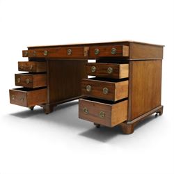 Late Victorian mahogany desk with red leather top, rectangular top with inset toold red leather writing surface, central long frieze drawer flanked by two short drawers, above pedestal with three graduating drawers with ring pull handles, on moulded plinth bases raised on castors