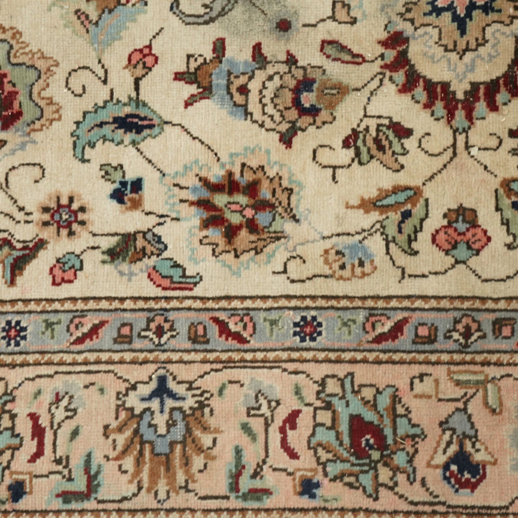 Persian Kashan rug, ivory ground field decorated with an all-over design of scrolling vines and stylized palmettes in pastel tones and conforming floral borders