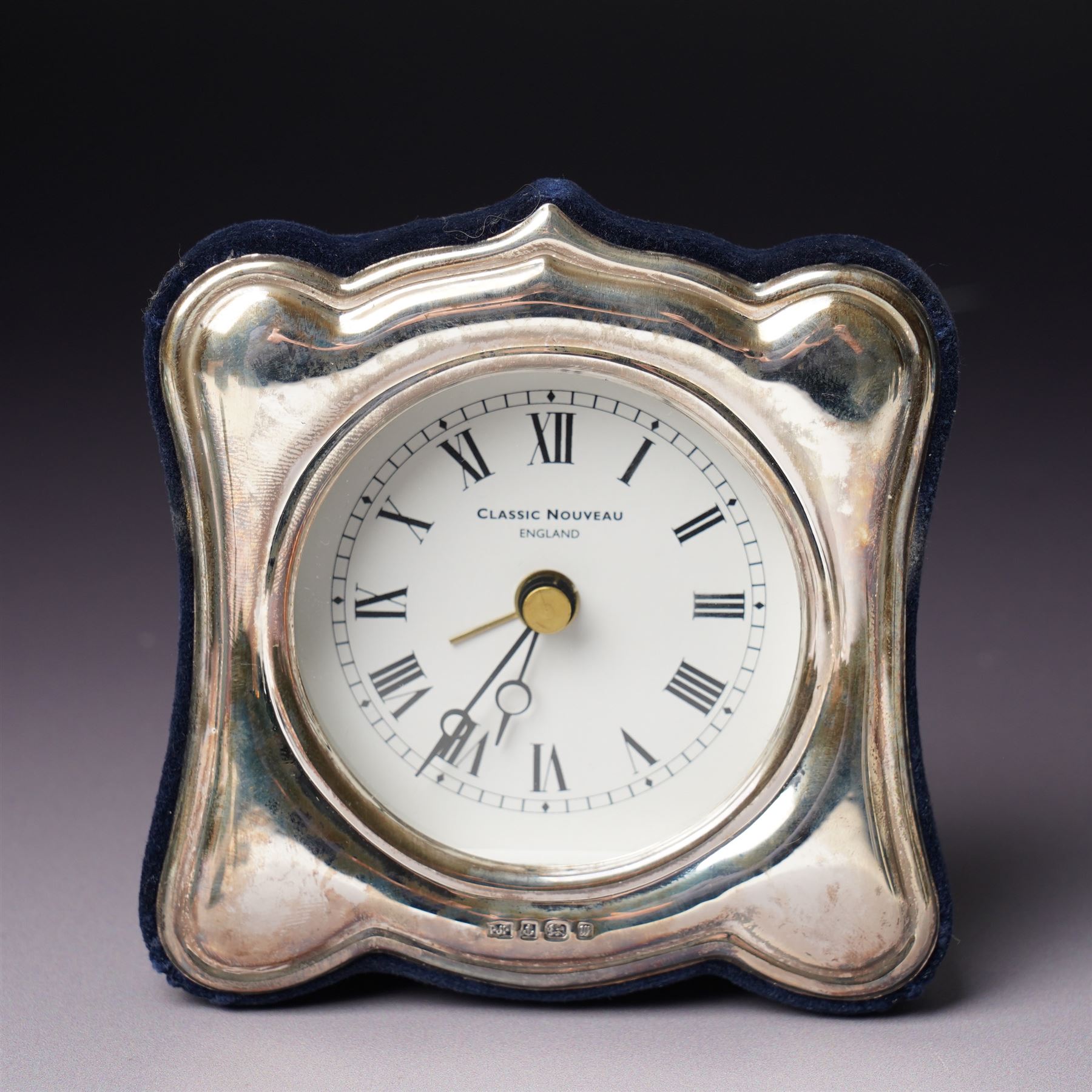 Tiffany silver teething ring marked 'Tiffany sterling 925', boxed, Junghans bedside clock in silver mounted frame, pair of silver sauce ladles and a silver knife