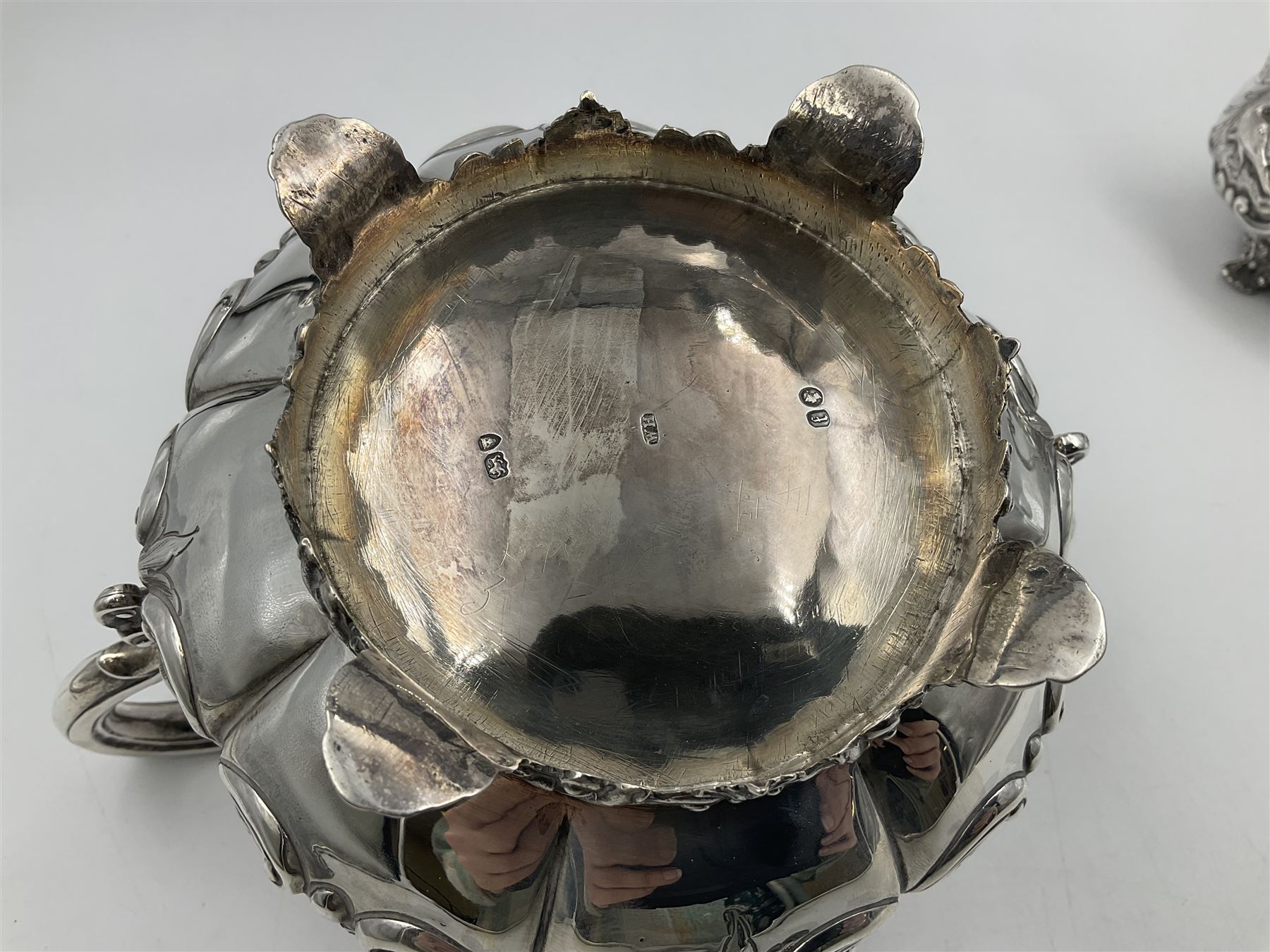 Victorian silver three piece tea service, comprising teapot, twin handled open sucrier, and milk jug, each of bellied form with acanthus capped scroll handles, the sides embossed with alternating scroll edged vacant panels and panels containing a pair of birds, upon four palmette feet, the teapot with ivory insulators to handle, and bird finial to the hinged domed cover, hallmarked William Hunter & Son, London 1861, teapot H19cm, including handles sucrier H13.5cm, including handle milk jug H12cm

This item has been registered for sale under Section 10 of the APHA Ivory Act