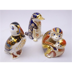  Three Royal Crown Derby paperweights: Monkey & baby dated 1992, silver stopper, Platypus dated 1988 & Puffin dated 1996, gold stoppers (3)   