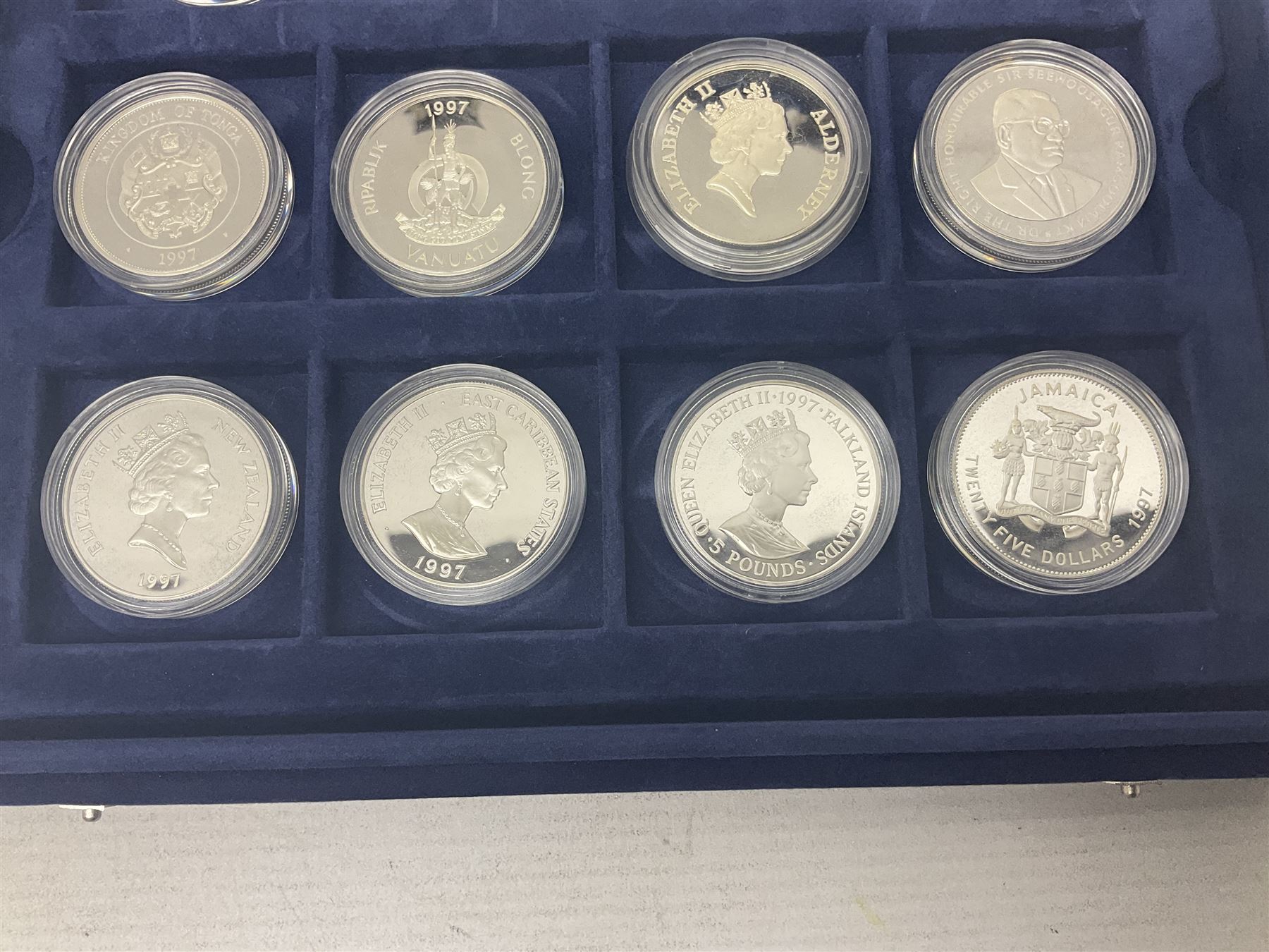 The Royal Mint Golden Wedding Anniversary silver proof coin collection, comprising twenty-four international commemorative coins, cased with certificates