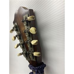 Late 19th/early 20th century Italian lute back mandolin with segmented back and spruce top; bears maker's label for Pietro Tonelli Napoli; together with a mandolin instruction booklet and a folding music stand L60.5cm