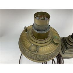 Victorian brass oil lamp converted to electricity, the square stepped base with a reeded doric column leading to a cut clear glass reservoir and burner and spherical shade with printed bird decoration, together with another similar shade and oil lamp parts and accessories etc