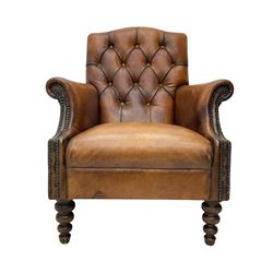Laura Ashley - hardwood-framed armchair, traditional shape with arched cresting rail over rolled arms, upholstered in buttoned brown leather with studded work, on turned front feet (W76cm, W95cm, D84cm); together with matching rectangular footstool (53cm x 34cm, H29cm)