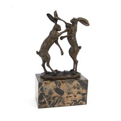 Mario Nick (Modern): two hares boxing, bronze figure group, signed Nick and bearing foundry mark, upon rectangular stone plinth, overall H23.5cm