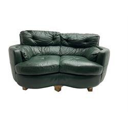 Two seat serpentine sofa, upholstered in green buttoned leather