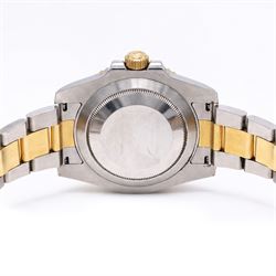 Rolex Oyster Perpetual Submariner Date gentleman's stainless steel and gold automatic wristwatch, Ref. 116613LN, serial No. 8201P7C5, back dial with luminous hour markers, unidirectional rotating black ceramic bezel, on stainless steel and yellow gold Rolex Oyster bracelet with fold-over clasp, boxed with guarantee card dated 2013