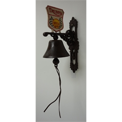  Modern 'Triumph Shell' cast iron hanging garage bell with painted shield on pierced wall bracket supporting a bell with leather pull H33cm  