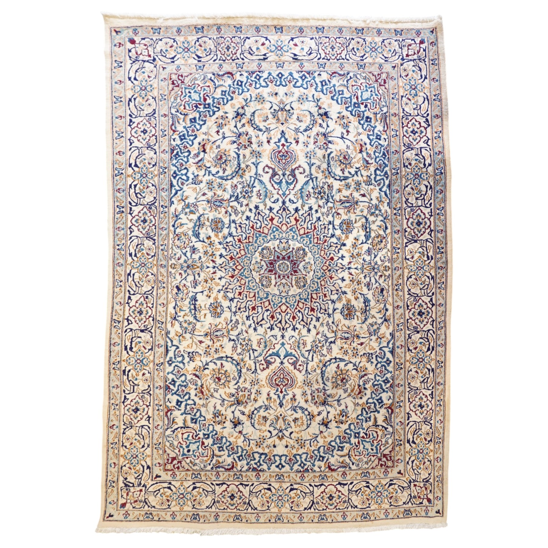 Persian Nain ivory ground rug, the busy oval field profusely decorated with scrolling foliate decoration and palmettes in citrine and indigo tones, the central medallion with matching spandrels, the multiple guard bands with repeating stylised quatrefoil motifs and trailing scrolling foliage and flowerheads