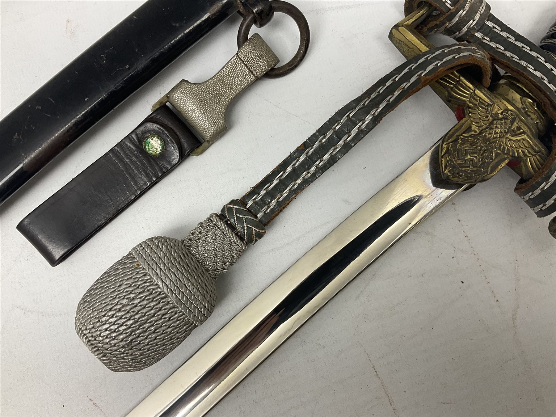 WW2 German Army Prinz Eugen Pattern Officers Dress Sword by Carl Eickhorn, the 80.5cm slightly curving fullered blade with makers name to the ricasso, gilt brass hilt with eagle to the cross-piece and relief of oakleaves to the ferrule, Prinz Eugen style down winged eagle to the pommel of the backstrap; grip retains the original wire binding; in original black painted scabbard with single hanging ring, leather hanger marked 'RZM M5/71 OLC' and silvered knot L97cm overall