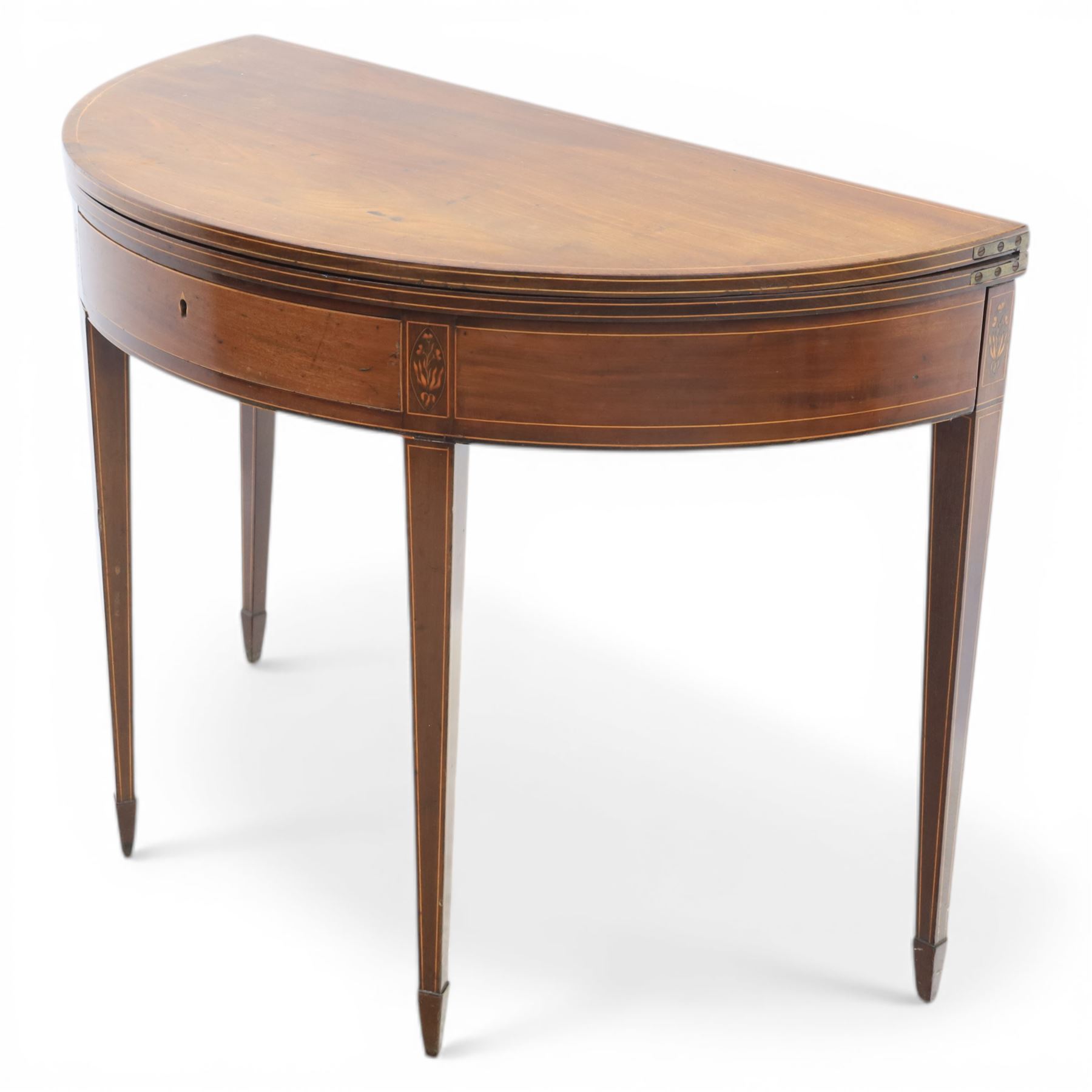 George III Scottish inlaid mahogany demi lune tea table, the curved fold over top opening to reveal a circular top with inlay to edge, above a frieze drawer with key, raised upon tapering inlaid legs with spade feet