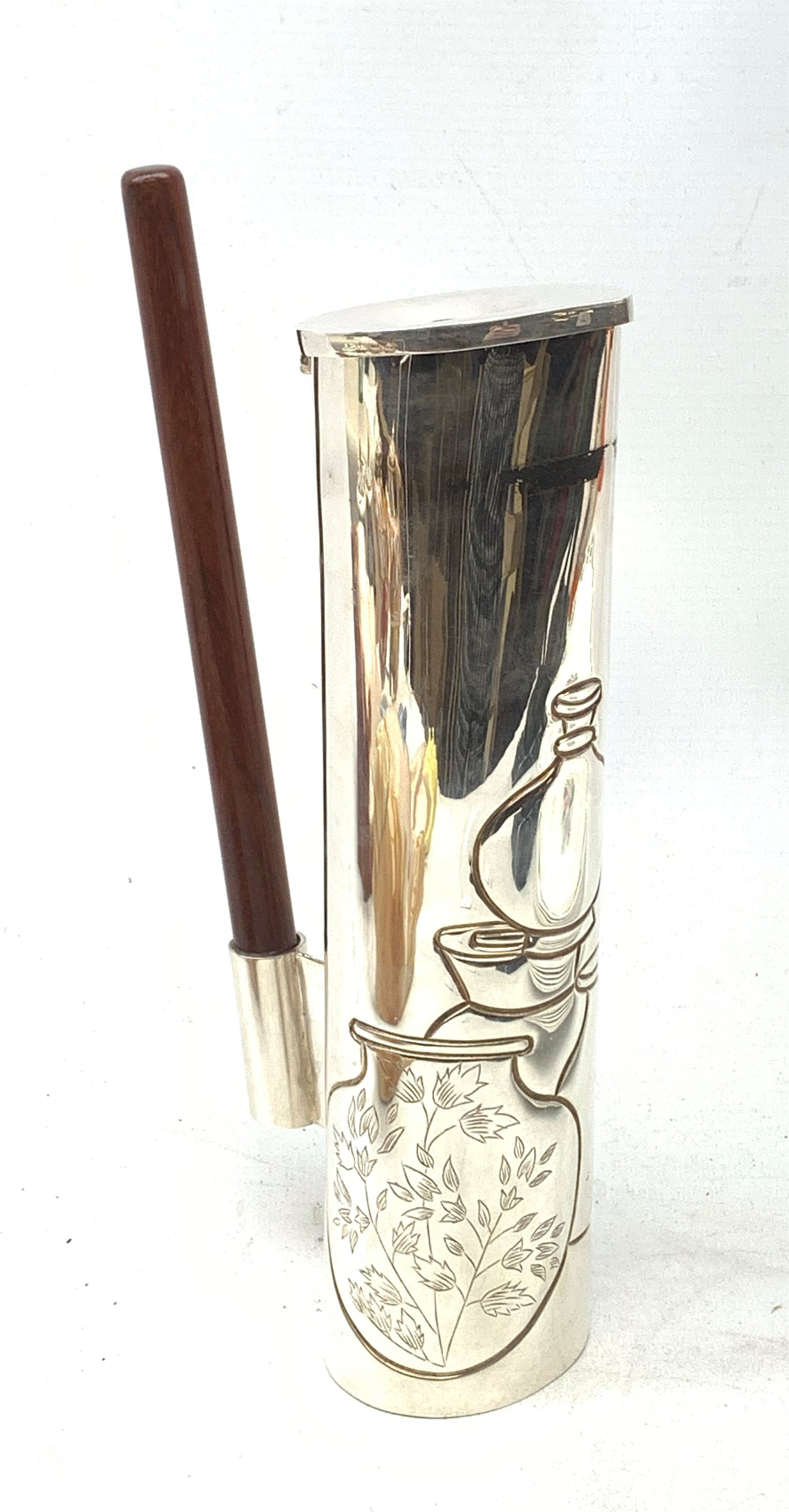 A silver plated Ravissant water jug, of cylindrical form with wooden open handle, detailed with a group of vases, marked beneath Ravissant, H25.5cm.  