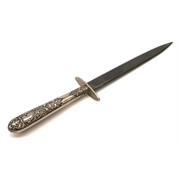 Knife with 15cm steel double edged flat blade, oval crosspiece and cutlery style plated scroll and foliate decorated handle with Victorian registration kite mark for March 1879, in stitched leather scabbard L26cm overall